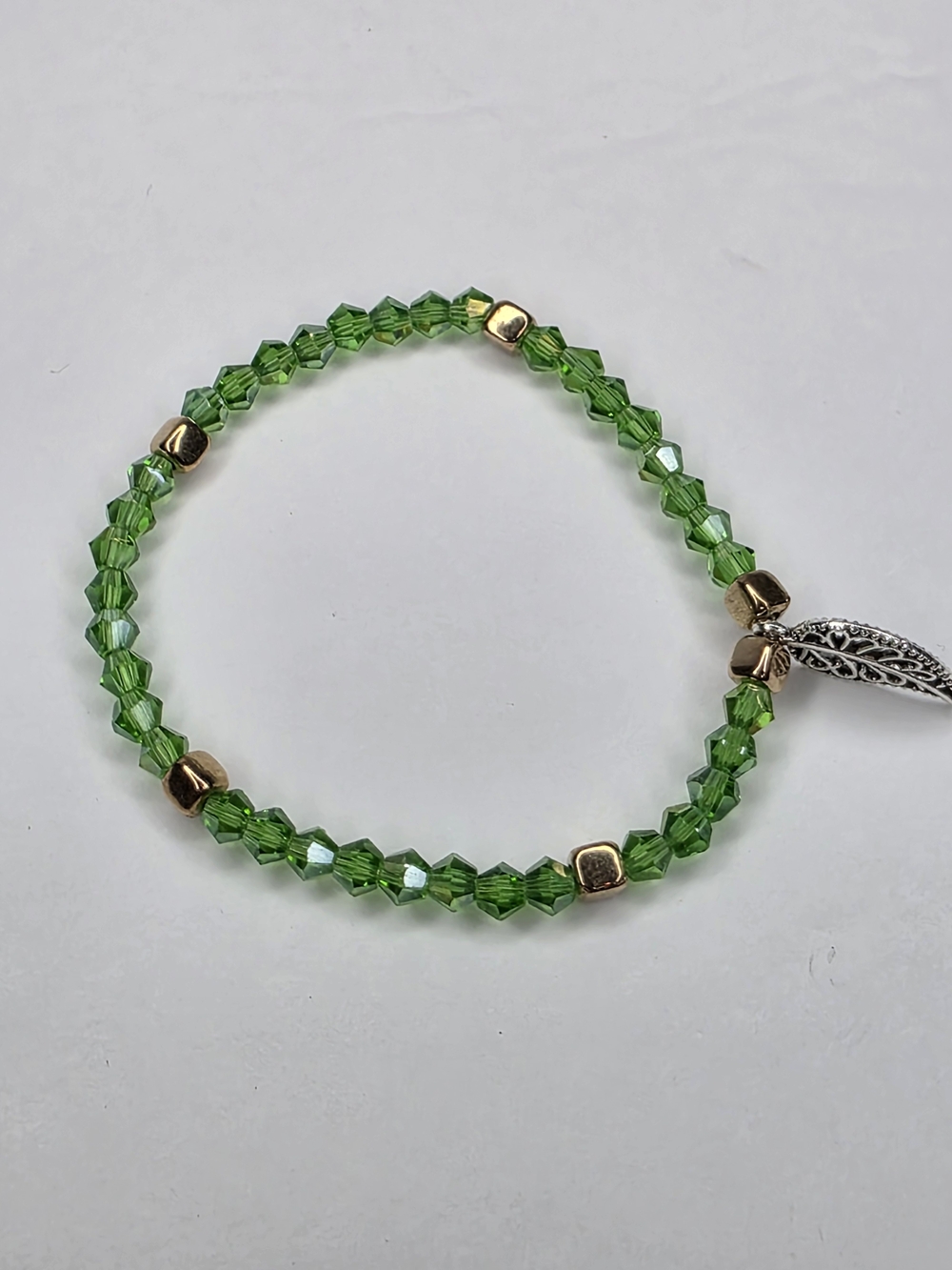 Green Crystal Bead Stretch Bracelet with Gold Accents And Leaf Charm